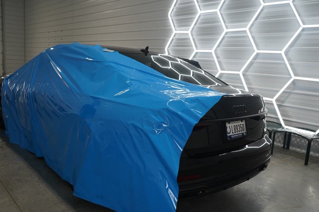 Audi A6 rear view, still wrapped in factory transport film on arrival